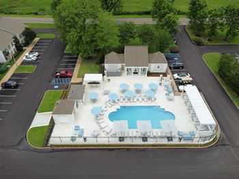 Arial view of a swimming pool in front of a house
